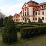 Historic mansion in Eichstätt, Germany, features beautiful topiary gardens and a classic facade.